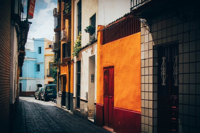 Mur jaune et rouge dans le quartier de la Macarena à Séville, voyage en espagne